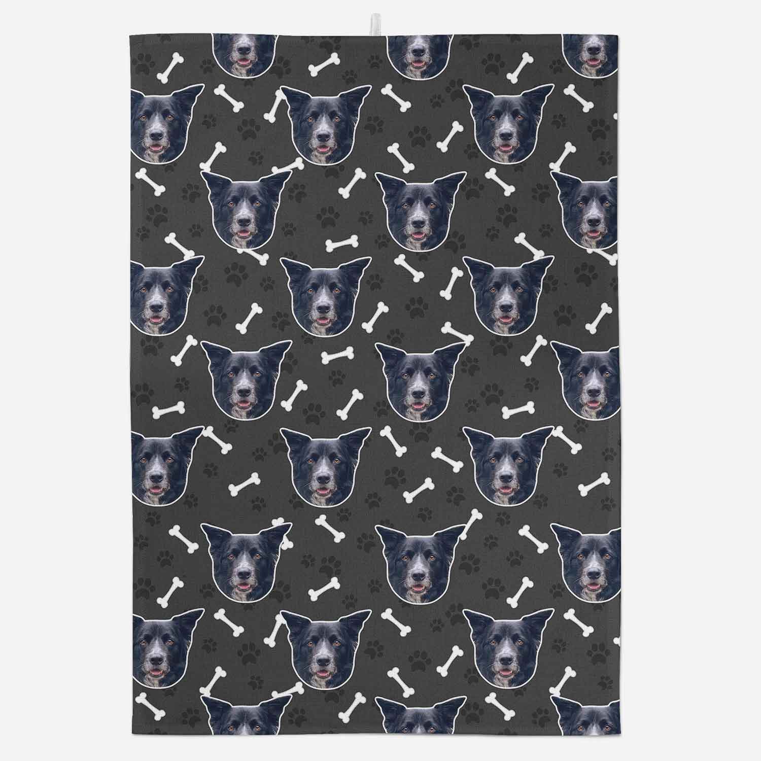 Patterned towel with repeated dog face design on a dark background