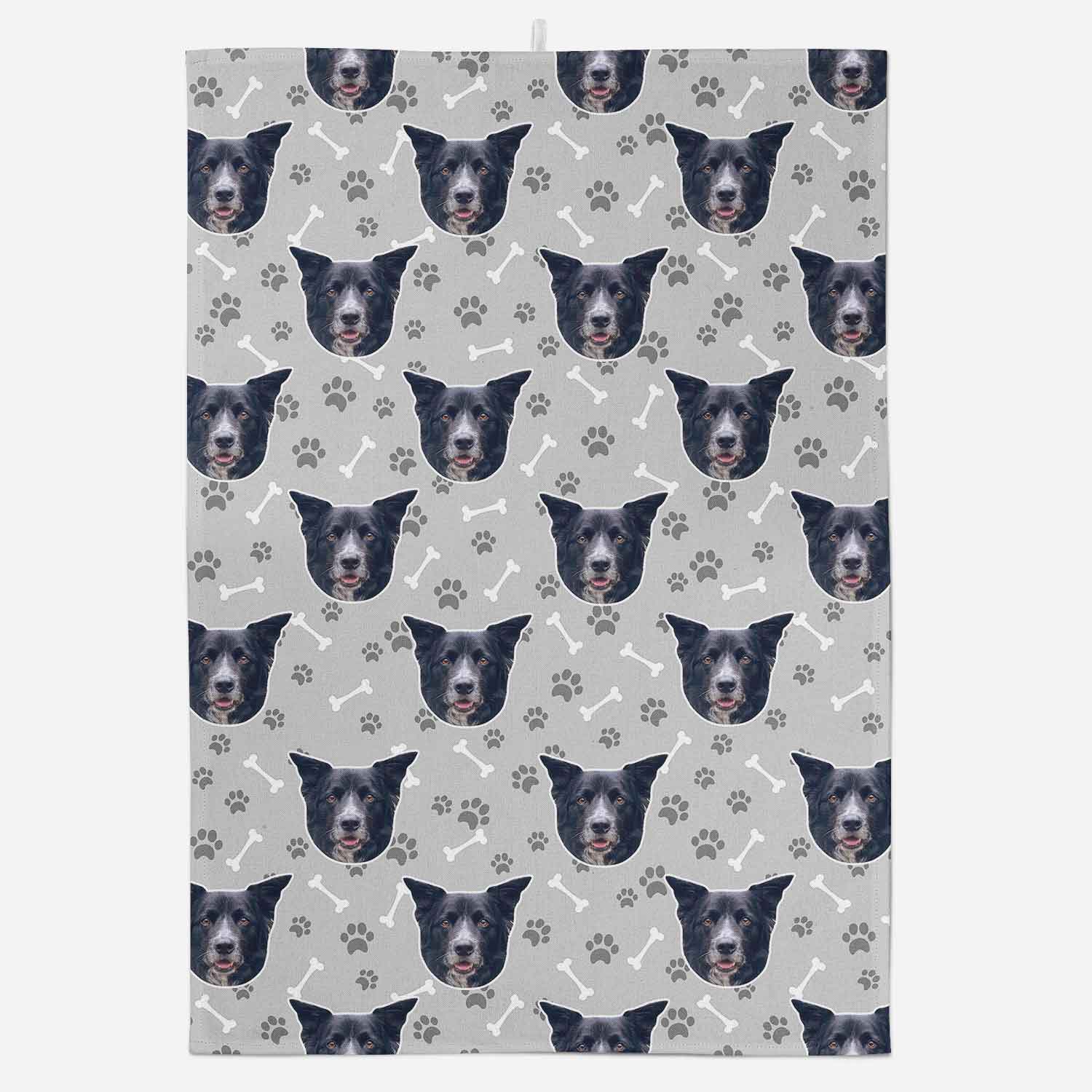 Patterned paper with repeated dog face design on a gray background