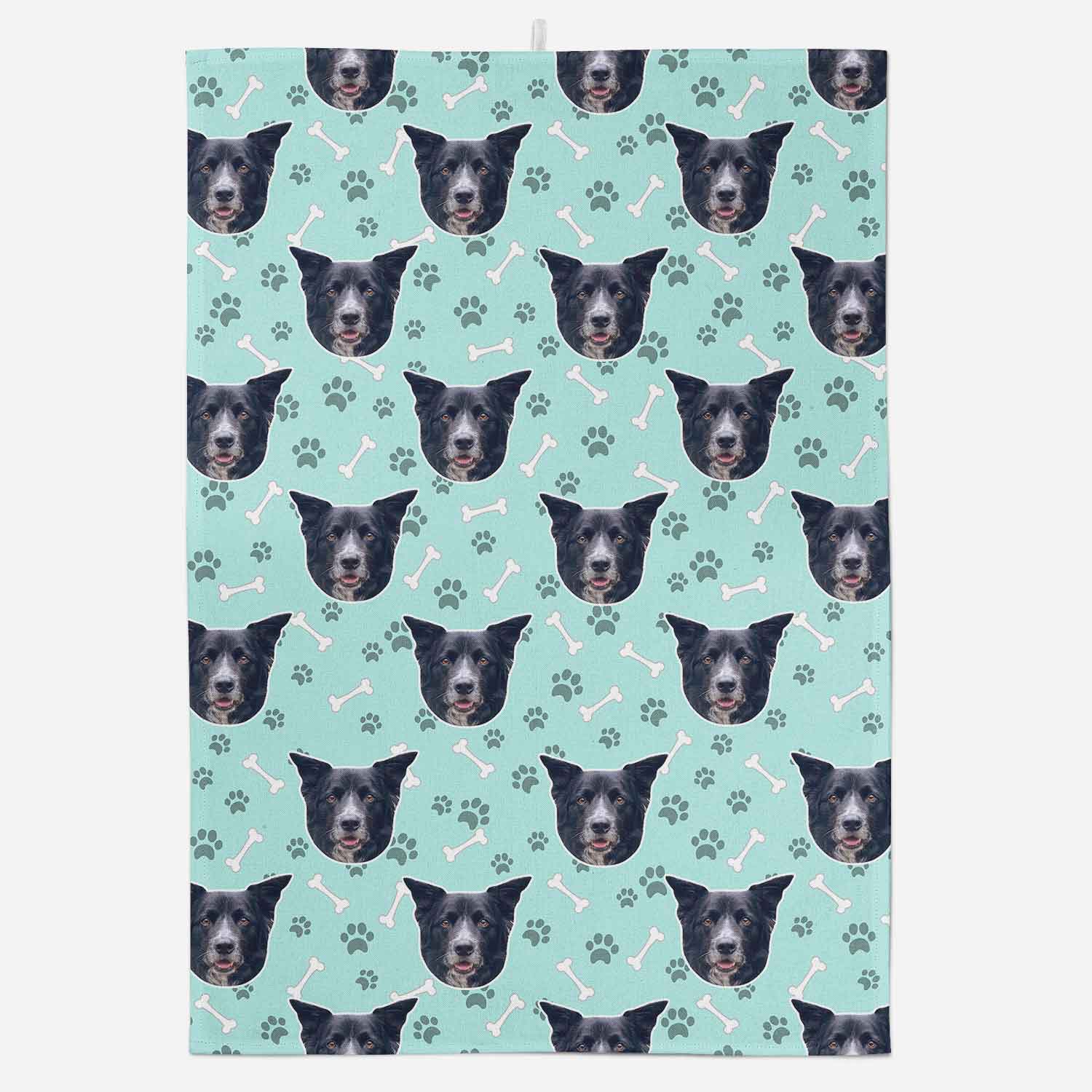 Patterned fabric with dog faces and bones on a light blue background