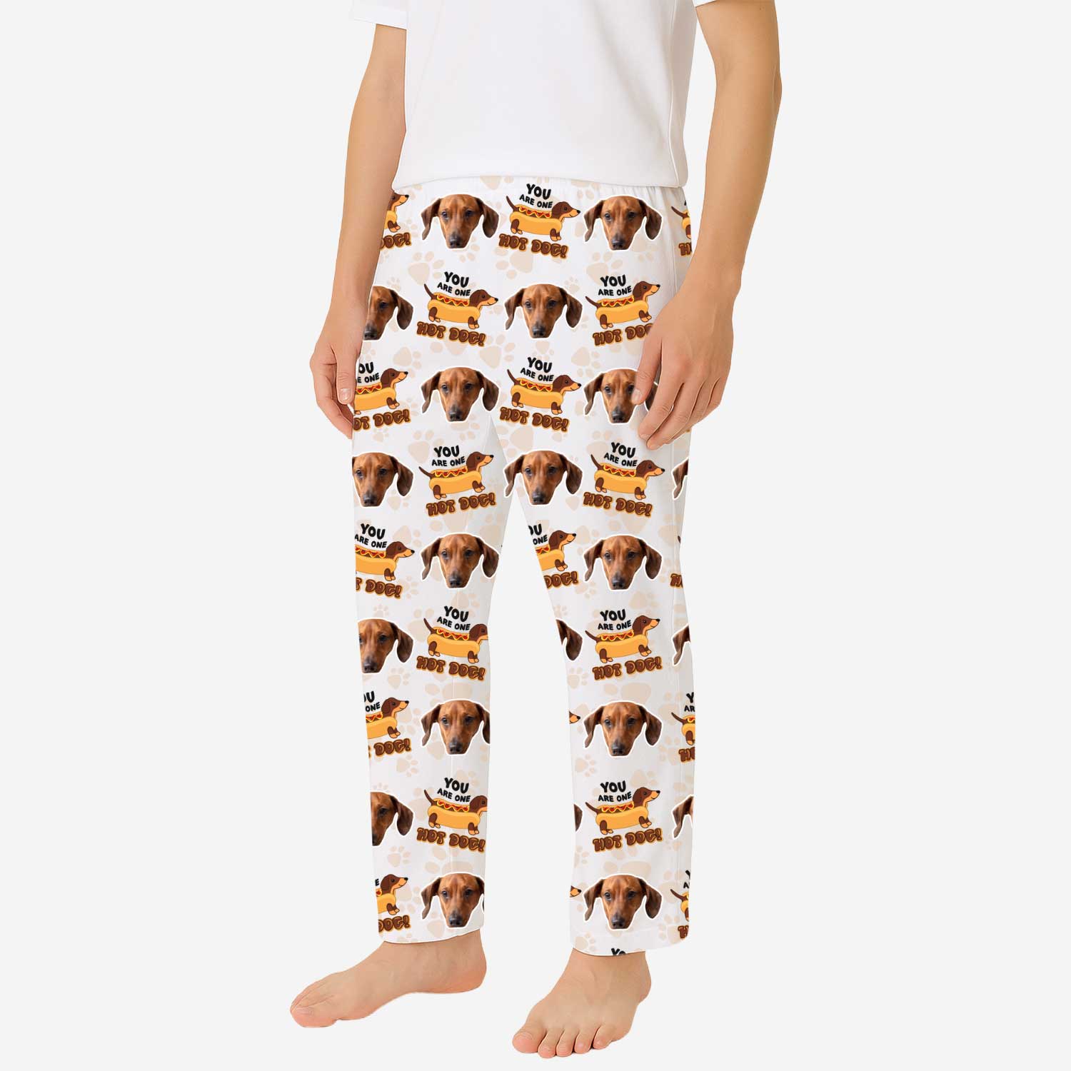 Person wearing pajama pants with dog pattern and text on a white background