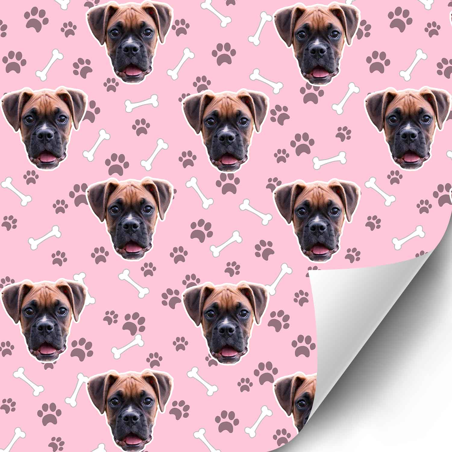 Pattern of a dog's face on pink paper with paw prints and bones.