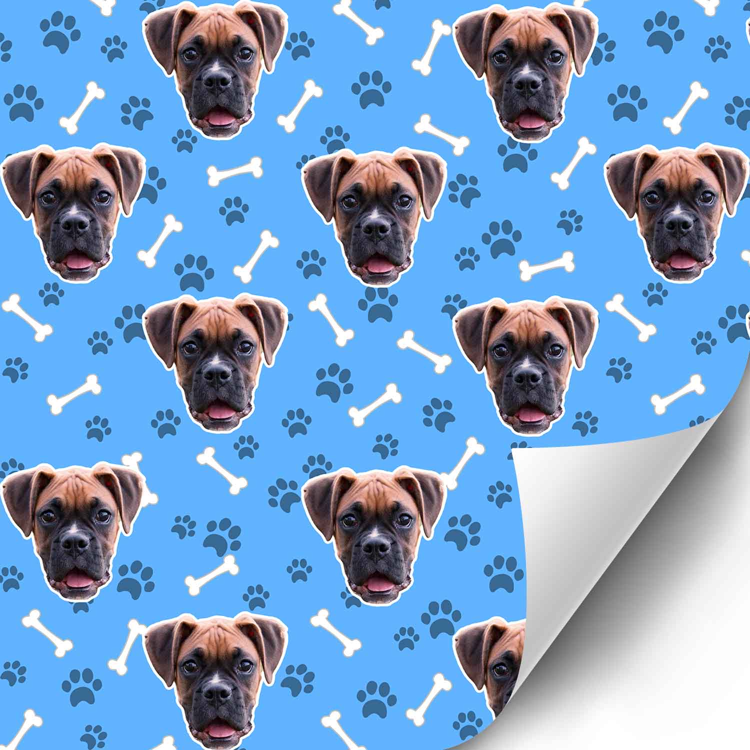 Patterned paper with dog faces and paw prints on a blue background